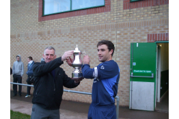 Tesco County League Chairman Graham Young present Windscale skipper Ryan Lowery with the Division 1 Title